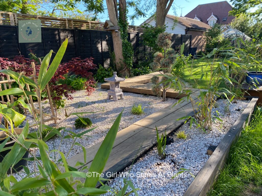 Japanese inspired wooden walkway with white stones made to look like water